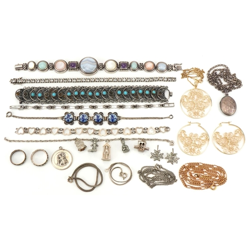 2694 - Vintage and later silver and white metal jewellery including a charm bracelet, floral engraved locke... 