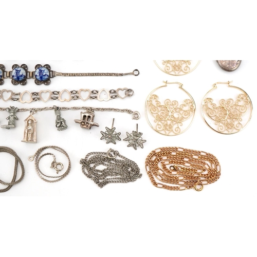 2694 - Vintage and later silver and white metal jewellery including a charm bracelet, floral engraved locke... 