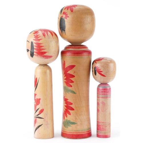 1357 - Three Japanese wooden and lacquered Kokeshi dolls, the largest 36cm high