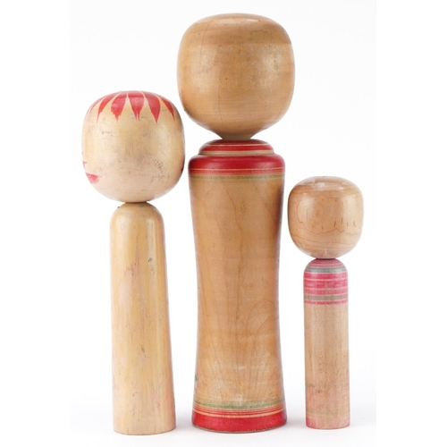 1357 - Three Japanese wooden and lacquered Kokeshi dolls, the largest 36cm high