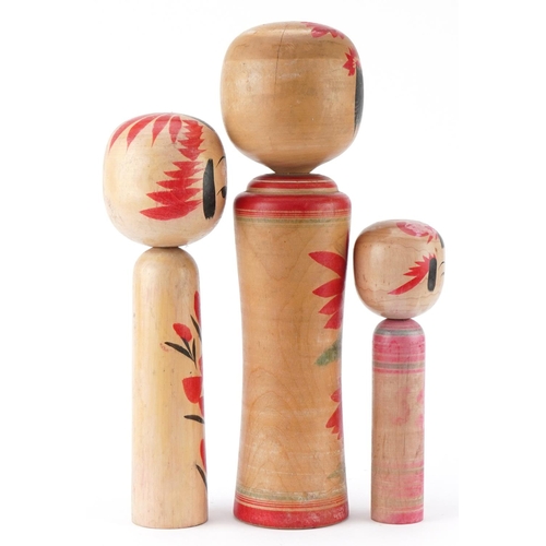 1357 - Three Japanese wooden and lacquered Kokeshi dolls, the largest 36cm high