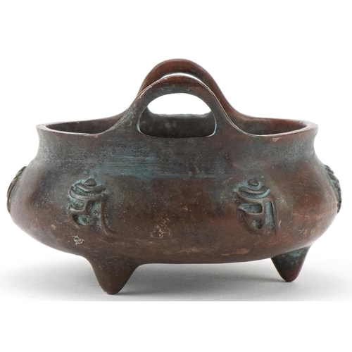 1433 - Chinese patinated bronze three footed censer with twin handles, 8cm wide