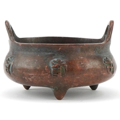 1433 - Chinese patinated bronze three footed censer with twin handles, 8cm wide