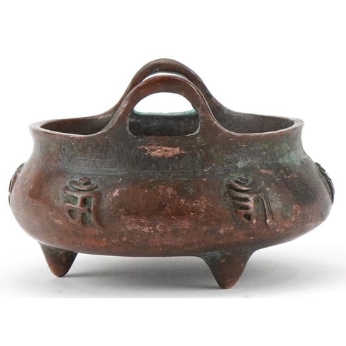 1433 - Chinese patinated bronze three footed censer with twin handles, 8cm wide