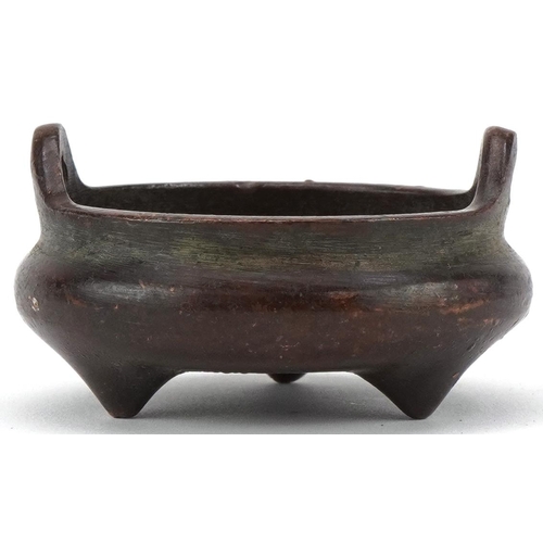 1392 - Chinese patinated bronze tripod censer with twin handles, 5.2cm in diameter