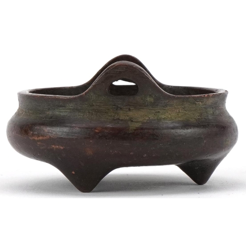 1392 - Chinese patinated bronze tripod censer with twin handles, 5.2cm in diameter