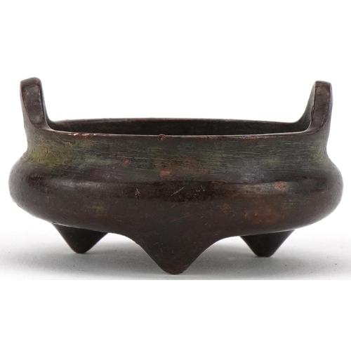 1392 - Chinese patinated bronze tripod censer with twin handles, 5.2cm in diameter