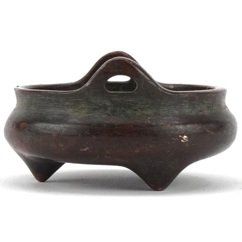 1392 - Chinese patinated bronze tripod censer with twin handles, 5.2cm in diameter