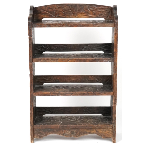 1072 - Manner of Liberty & Co, Japanese hardwood bookcase carved with flowers, 98cm H x 60cm wide, 24cm D