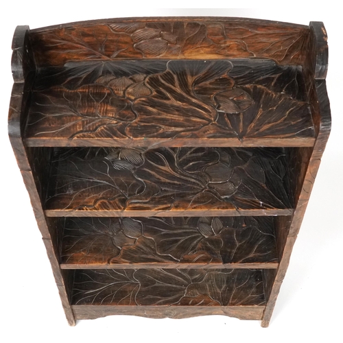 1072 - Manner of Liberty & Co, Japanese hardwood bookcase carved with flowers, 98cm H x 60cm wide, 24cm D