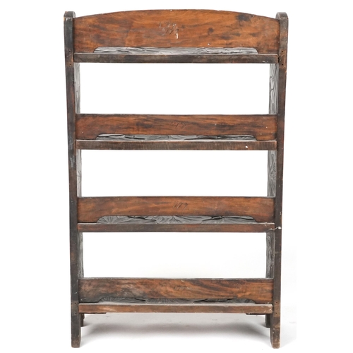 1072 - Manner of Liberty & Co, Japanese hardwood bookcase carved with flowers, 98cm H x 60cm wide, 24cm D