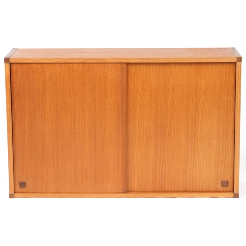 1053 - Beaver & Tapley, mid century Scandinavian design teak modular wall cupboard with a pair of sliding d... 