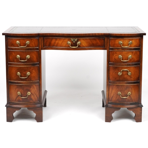 1012 - Mahogany serpentine front twin pedestal desk and a mahogany chair, the desk with nine drawers and gr... 