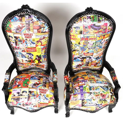 1013 - Pair of ebonised child's elbow chairs with comic upholstery, 100cm high