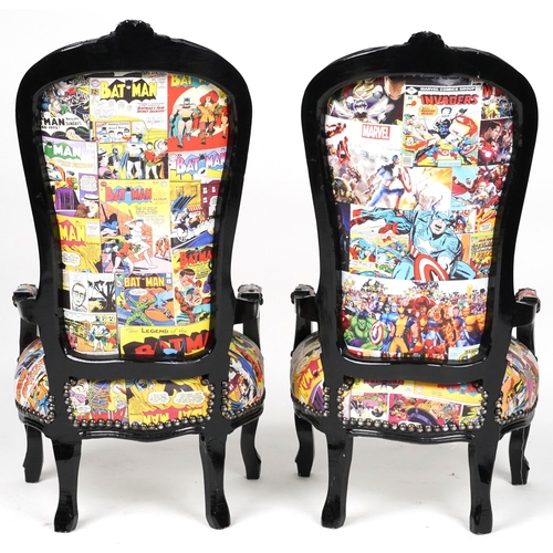 1013 - Pair of ebonised child's elbow chairs with comic upholstery, 100cm high