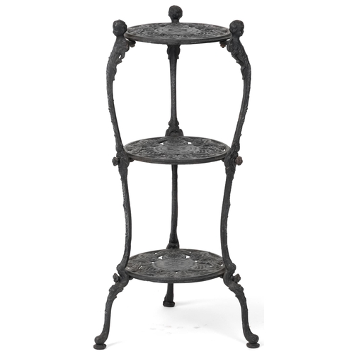 1089 - Victorian style cast iron three tier plant stand with figural mounts, 74cm high