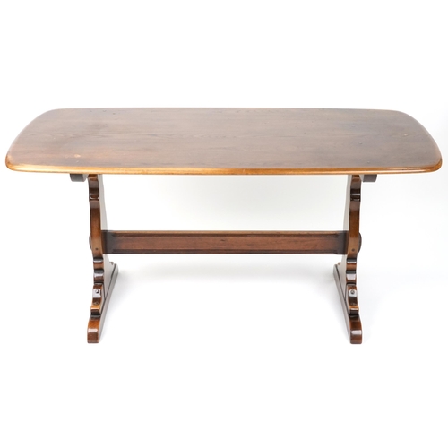 1027 - Ercol elm dining table and six stick back chairs, the table 72cm H x 152cm W x 76cm D