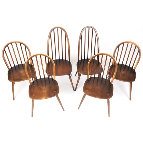 1027 - Ercol elm dining table and six stick back chairs, the table 72cm H x 152cm W x 76cm D