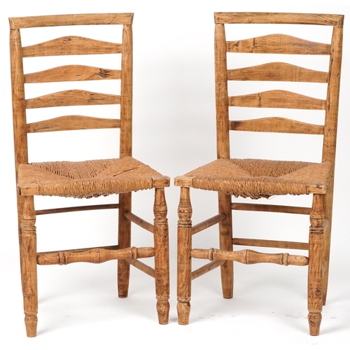 1116 - Pair of beech ladderback chairs with cane seats, each 93cm high