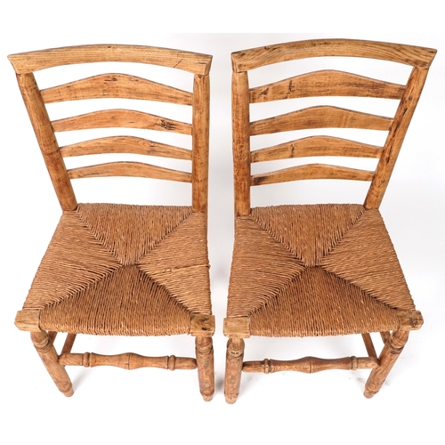 1116 - Pair of beech ladderback chairs with cane seats, each 93cm high