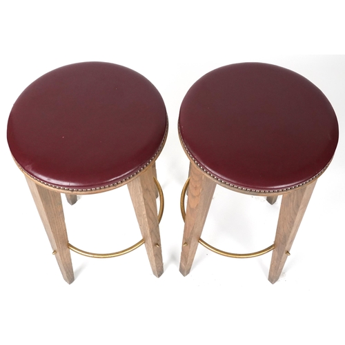 1070 - Pair of contemporary breakfast bar stools with burgundy leather upholstered padded seats, each 72cm ... 