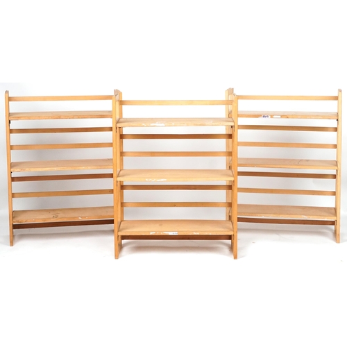 1106 - Three folding lightwood three shelf bookcases, each 91cm H x 72cm W x 29.5cm D