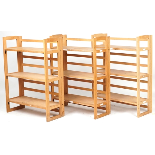 1106 - Three folding lightwood three shelf bookcases, each 91cm H x 72cm W x 29.5cm D