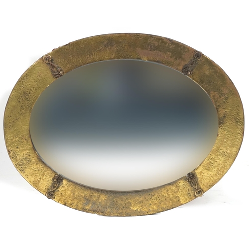 1133 - Arts & Craft brass oval wall mirror with bevelled glass, 75cm x 58cm