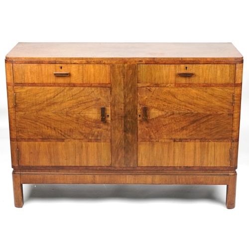 1005 - Maple and Co, Art Deco walnut sideboard with two drawers above a pair of cupboard doors enclosing sh... 