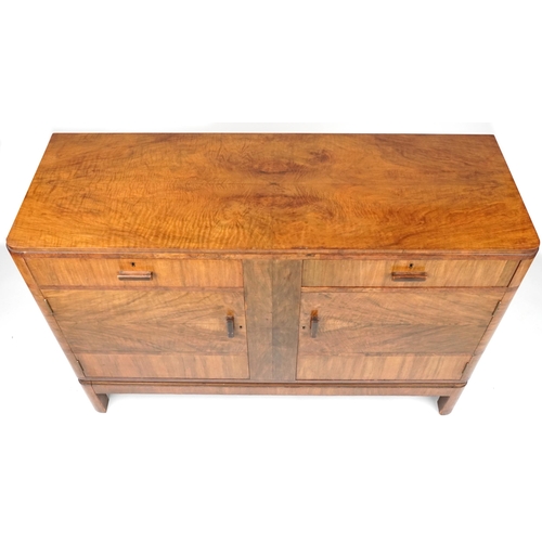 1005 - Maple and Co, Art Deco walnut sideboard with two drawers above a pair of cupboard doors enclosing sh... 