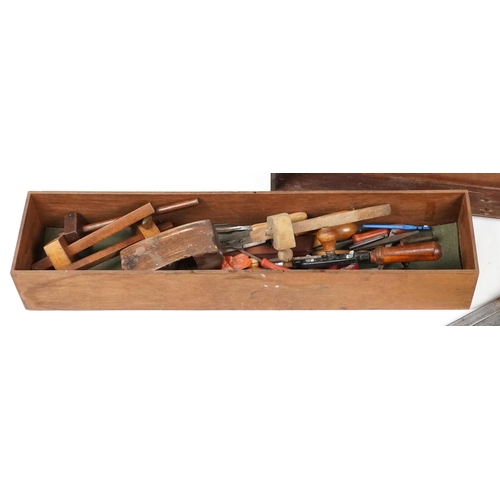 1061 - Antique and later  woodworking tools housed in a stained pine carpenter's box, 76cm wide