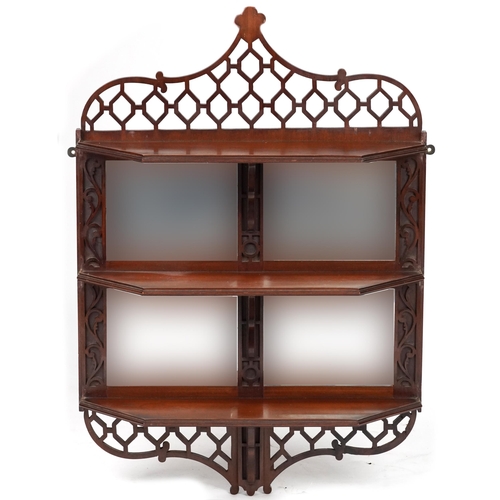 1019 - Mahogany wall hanging open fretwork wall hanging shelves with bevelled glass mirrored back, 84cm H x... 