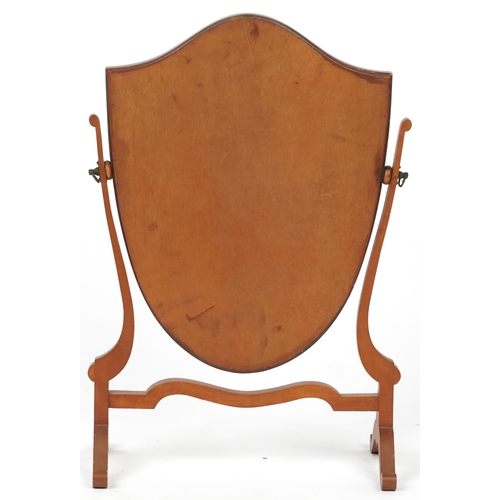 1057 - Mahogany shield shaped swing mirror, 58cm high