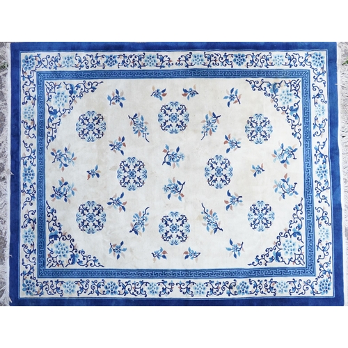 1123 - Large Chinese blue and cream ground rug having an allover floral design, 370cm x 275cm