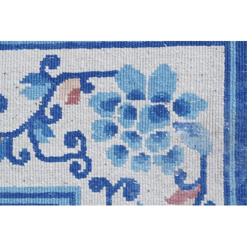 1123 - Large Chinese blue and cream ground rug having an allover floral design, 370cm x 275cm