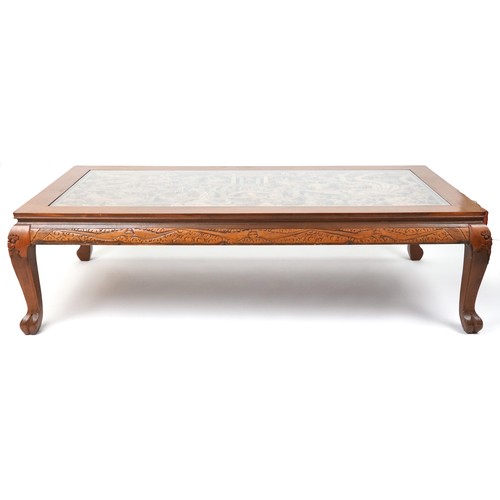 1006 - Large Chinese hardwood and glass coffee table profusely carved with dragons and figures, 52cm H x 18... 