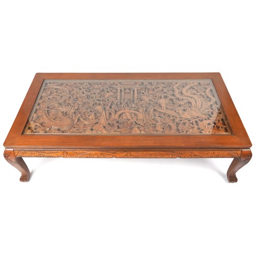 1006 - Large Chinese hardwood and glass coffee table profusely carved with dragons and figures, 52cm H x 18... 