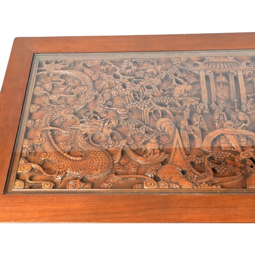 1006 - Large Chinese hardwood and glass coffee table profusely carved with dragons and figures, 52cm H x 18... 