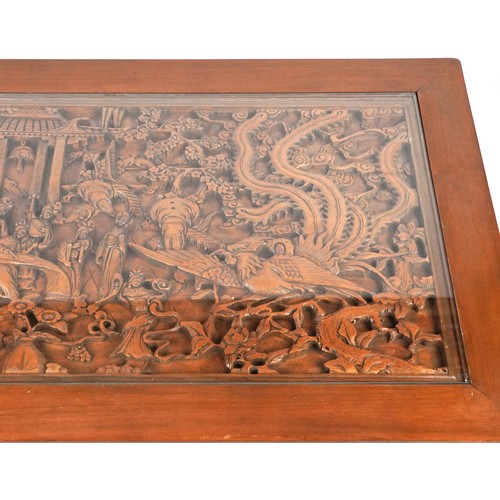 1006 - Large Chinese hardwood and glass coffee table profusely carved with dragons and figures, 52cm H x 18... 