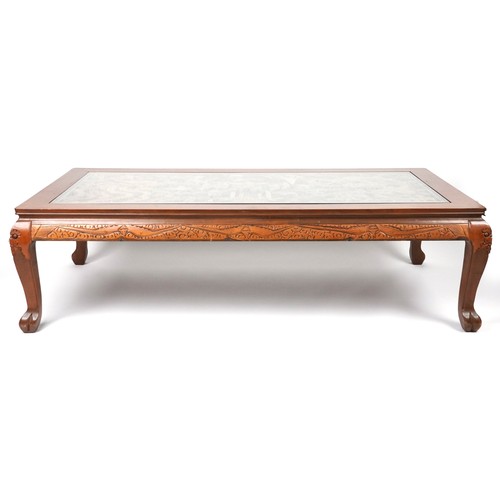 1006 - Large Chinese hardwood and glass coffee table profusely carved with dragons and figures, 52cm H x 18... 