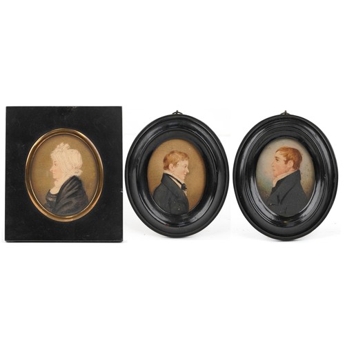 461 - Three Georgian oval hand painted portrait miniatures housed in ebonised frames, including one of an ... 