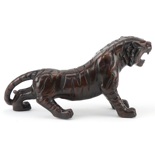 1330 - Japanese patinated bronze okimono of a tiger, 34cm in length