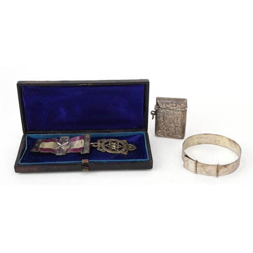 336 - Silver objects comprising floral engraved vesta, floral engraved bracelet and a masonic jewel with r... 