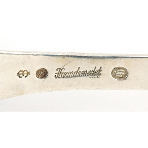 2442 - S A J Jacobsen, Danish silver spoon inscribed Haandsmedet, the terminal pierced with stylised flower... 