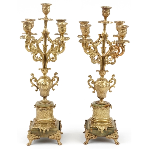 96 - Pair of Victorian Rococo style four branch gilded brass candelabra on green marble bases, each 50cm ... 