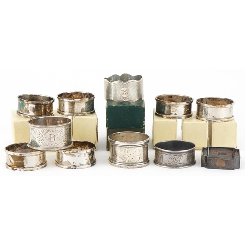 2454 - Eleven Edwardian and later silver napkin rings, some with boxes, the largest 5cm in diameter, total ... 