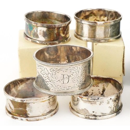 2454 - Eleven Edwardian and later silver napkin rings, some with boxes, the largest 5cm in diameter, total ... 