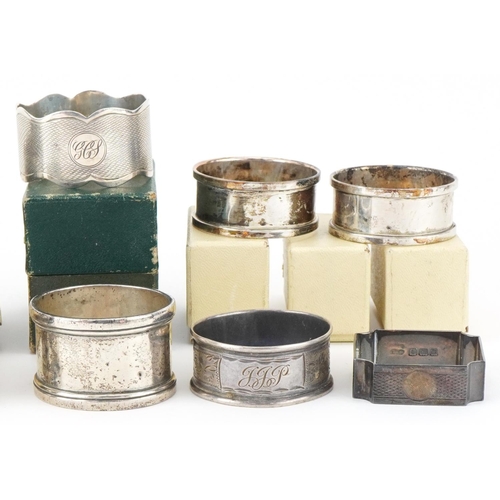 2454 - Eleven Edwardian and later silver napkin rings, some with boxes, the largest 5cm in diameter, total ... 