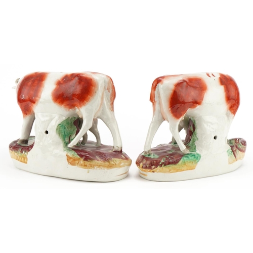 186 - Pair of Victorian hand painted Staffordshire pottery groups of cows and calves, each 19cm high