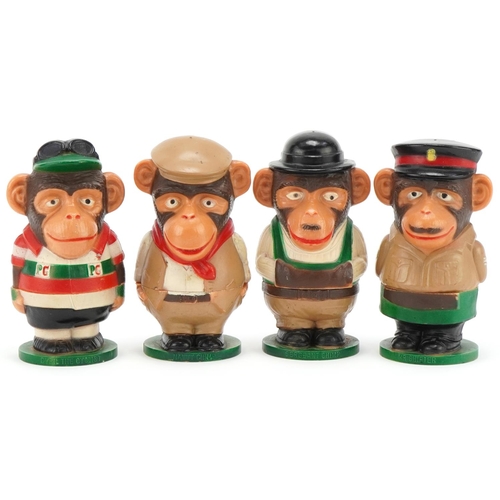 Four vintage PG Tips chimp plastic eggcups and covers, each 11cm high